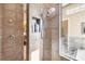 Walk-in shower with dual shower head, built-in toiletry shelf, and glass partition showcasing the adjacent soaking tub at 5245 88Th E St, Bradenton, FL 34211