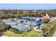 Overhead shot of community tennis courts with shaded seating and well-maintained green surfaces at 5245 88Th E St, Bradenton, FL 34211