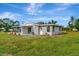 Large backyard with grassy lawn and partial view of home at 5411 16Th W St, Bradenton, FL 34207