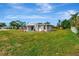 Large backyard with grassy lawn and partial view of home at 5411 16Th W St, Bradenton, FL 34207