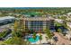 Luxury building with pool and lush landscaping at 5560 Cannes Cir # 3-106, Sarasota, FL 34231
