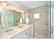 Double vanity bathroom with a large walk-in shower at 5560 Cannes Cir # 3-106, Sarasota, FL 34231