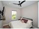 Cozy bedroom with a queen bed and ceiling fan at 5560 Cannes Cir # 3-106, Sarasota, FL 34231