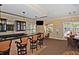 Clubhouse bar with seating, granite countertop and flat screen TV at 5560 Cannes Cir # 3-106, Sarasota, FL 34231
