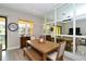 Dining area with a wooden table, bench seating, and mirrored accent wall at 5560 Cannes Cir # 3-106, Sarasota, FL 34231
