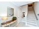 Bright entryway with a console table, mirror, and staircase leading upstairs at 5560 Cannes Cir # 3-106, Sarasota, FL 34231