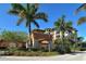 Community building with palm trees and a porte cochere at 5560 Cannes Cir # 3-106, Sarasota, FL 34231