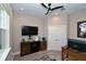 Bright home office with built-in cabinetry and a large TV at 5560 Cannes Cir # 3-106, Sarasota, FL 34231