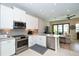Modern kitchen with stainless steel appliances and white cabinetry at 5560 Cannes Cir # 3-106, Sarasota, FL 34231