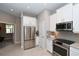 Modern kitchen with stainless steel appliances and white cabinetry at 5560 Cannes Cir # 3-106, Sarasota, FL 34231