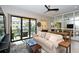 Living room with sliding glass doors to balcony and a mirrored wall at 5560 Cannes Cir # 3-106, Sarasota, FL 34231