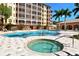 Relaxing spa tub adjacent to refreshing pool at 5560 Cannes Cir # 3-106, Sarasota, FL 34231
