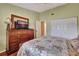 Bedroom with wood floors, large dresser, and comfortable bed at 5574 Ashton Lake Dr # 5574, Sarasota, FL 34231