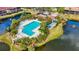 Community pool with lounge chairs, surrounded by lush landscaping at 5574 Ashton Lake Dr # 5574, Sarasota, FL 34231