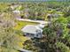 Single-story house in a wooded neighborhood at 5629 Crenshaw Ln, North Port, FL 34286