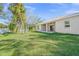 Spacious backyard with lush lawn and covered patio at 5629 Crenshaw Ln, North Port, FL 34286