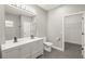 Bright bathroom featuring a double vanity, toilet and access to a walk-in closet at 5629 Crenshaw Ln, North Port, FL 34286