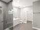 Modern bathroom with a large walk-in shower, double vanity, and gray tile floors at 5629 Crenshaw Ln, North Port, FL 34286