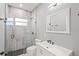 Updated bathroom with a single vanity, toilet and walk-in shower at 5629 Crenshaw Ln, North Port, FL 34286
