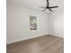 Bright bedroom with hardwood floors, large window, and ceiling fan at 5629 Crenshaw Ln, North Port, FL 34286