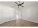 Spacious bedroom with hardwood floors, double doors and ceiling fan at 5629 Crenshaw Ln, North Port, FL 34286