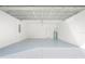 Clean and spacious garage with epoxy floor and open overhead door at 5629 Crenshaw Ln, North Port, FL 34286