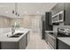 Modern kitchen with stainless steel appliances and white countertops at 5629 Crenshaw Ln, North Port, FL 34286