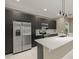 Modern kitchen with dark cabinetry and a large island at 5629 Crenshaw Ln, North Port, FL 34286