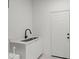 Laundry room with utility sink, white cabinets and built in storage at 5629 Crenshaw Ln, North Port, FL 34286