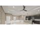 Open concept living area with modern kitchen and neutral color scheme at 5629 Crenshaw Ln, North Port, FL 34286