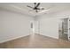 Main bedroom with ceiling fan and access to bathroom at 5629 Crenshaw Ln, North Port, FL 34286
