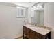 Clean bathroom with granite countertop, modern vanity, and a large mirror at 6144 Midnight Pass Rd # 2N, Sarasota, FL 34242