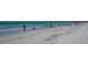 Beautiful beach with white sand and clear water, people enjoying a sunny day at 6144 Midnight Pass Rd # 2N, Sarasota, FL 34242