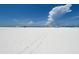 Expansive beach view with white sand and blue sky at 6144 Midnight Pass Rd # 2N, Sarasota, FL 34242