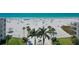 Beachfront property with clear water, white sand, and palm trees at 6144 Midnight Pass Rd # 2N, Sarasota, FL 34242