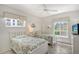 Guest bedroom with twin beds, ceiling fan and plenty of natural light at 6144 Midnight Pass Rd # 2N, Sarasota, FL 34242