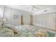 Bright bedroom with a comfortable bed, built-in closet and ceiling fan at 6144 Midnight Pass Rd # 2N, Sarasota, FL 34242