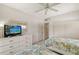 Guest bedroom with twin beds, ceiling fan and plenty of natural light at 6144 Midnight Pass Rd # 2N, Sarasota, FL 34242