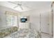 Guest bedroom with twin beds, ceiling fan and plenty of natural light at 6144 Midnight Pass Rd # 2N, Sarasota, FL 34242