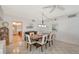 Bright dining room with wood table and six chairs, views into kitchen and living areas at 6144 Midnight Pass Rd # 2N, Sarasota, FL 34242
