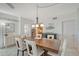 Spacious dining area with a large wooden table and six light-colored chairs at 6144 Midnight Pass Rd # 2N, Sarasota, FL 34242