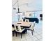 Open dining room with dark wood table and chairs, adjacent to living room at 6144 Midnight Pass Rd # 2N, Sarasota, FL 34242