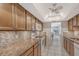 Kitchen features granite countertops, wood cabinets, and tile backsplash at 6144 Midnight Pass Rd # 2N, Sarasota, FL 34242