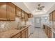 Kitchen with granite countertops, wood cabinets and tile backsplash at 6144 Midnight Pass Rd # 2N, Sarasota, FL 34242