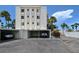 View of building and covered parking spaces at 6144 Midnight Pass Rd # 2N, Sarasota, FL 34242