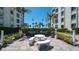 Community patio with grills and seating, near condo building at 6144 Midnight Pass Rd # 2N, Sarasota, FL 34242