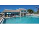 Community pool area with surrounding lounge chairs and building at 6144 Midnight Pass Rd # 2N, Sarasota, FL 34242