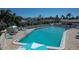 Community pool with lounge chairs, umbrellas and surrounding buildings at 6144 Midnight Pass Rd # 2N, Sarasota, FL 34242