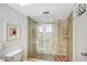 Updated shower with glass enclosure, tile surround, and built-in shelves at 6144 Midnight Pass Rd # 2N, Sarasota, FL 34242