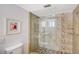 Updated shower with glass enclosure, tile surround, and built-in shelves at 6144 Midnight Pass Rd # 2N, Sarasota, FL 34242